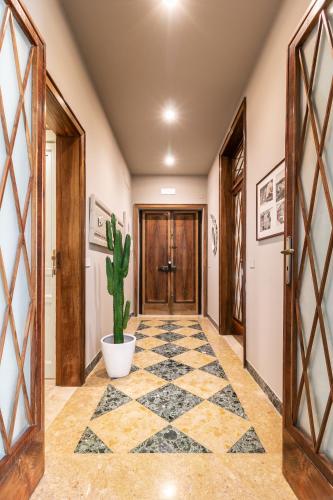 a hallway with a potted plant and a door at Autentica Ortigia in Siracusa