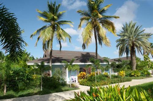 a house with palm trees in front of it at Trupial Hotel & Casino in Willemstad