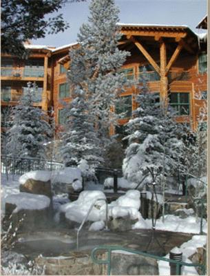 a snow covered yard in front of a lodge at Teton Club in Teton Village