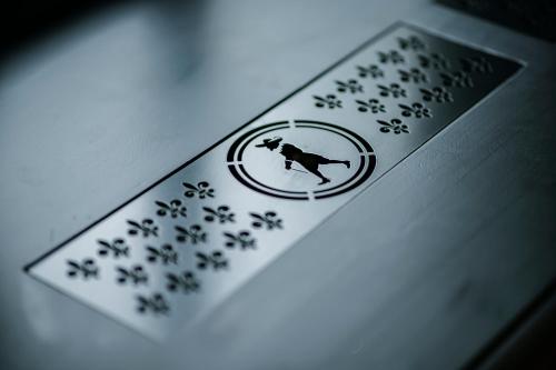 a card with a picture of a dog and paw prints at Boutique Hotel The Noblemen in Amsterdam