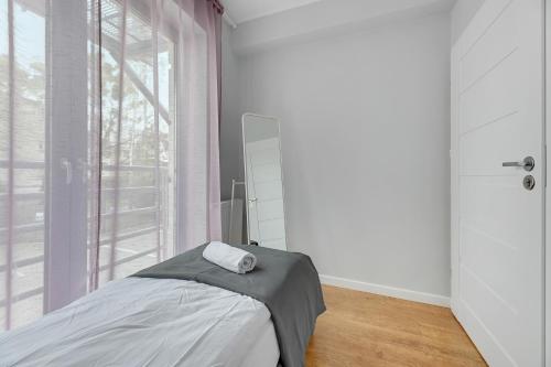 a bedroom with a bed and a large window at Przystanek Sopot Plaża in Sopot
