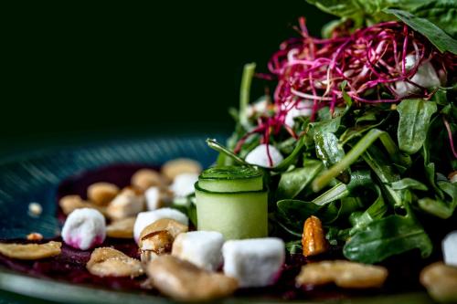 a plate of food with a salad and vegetables at Grand Café Goejje in Meijel
