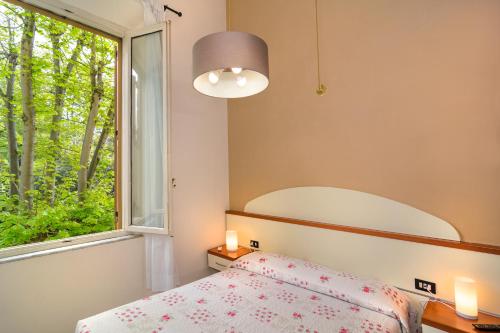 a bedroom with a bed and a window at Villa Grazia in Viareggio