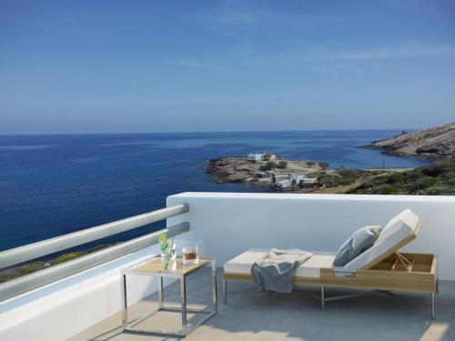 a balcony with a view of the ocean at The Mykonist Merchia Beach Villas & Suites in Merchia Beach