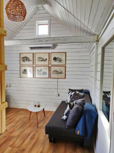 a bedroom with a bed and a table at Lillstugan - Centralt och havsnära i lugnt villområde in Falkenberg