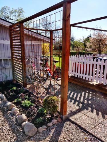 a bike parked next to a white fence at Lillstugan - Centralt och havsnära i lugnt villområde in Falkenberg