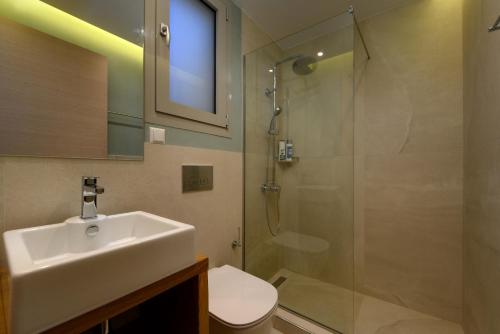 a bathroom with a sink and a shower at Tessera Villas & Studios Collection in Gouvia