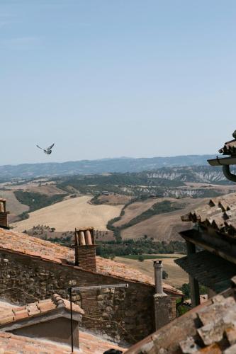 a plane flying over a stone building with a field at Bed & Basta in Allerona