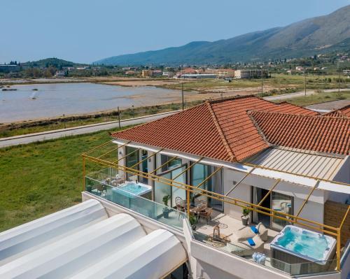 a balcony of a house with a view of a river at Aphrodite Studios & Suites in Alykes