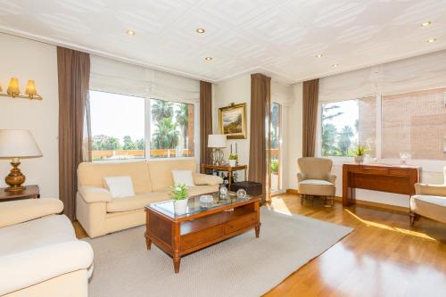 a living room with a couch and a table at HomeHolidaysRentals Amaral in Pineda de Mar