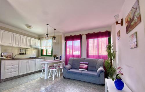 a living room with a couch and a table in a kitchen at Home2Book Relax Apartment Buenavista in Buenavista del Norte