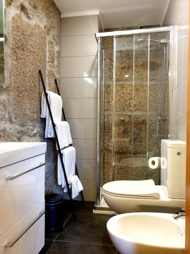a bathroom with a shower and a toilet and a sink at Quinta da Casa dos Santos - Inside Gerês in Geres