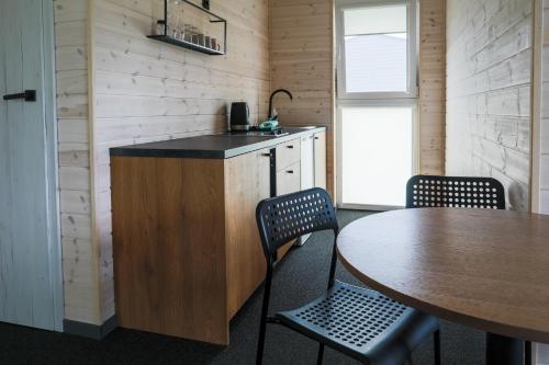 a kitchen with a table and a table and chairs at Jūros 40 in Šventoji