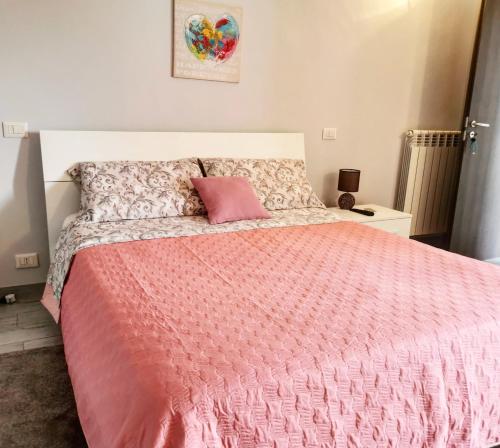 ein Schlafzimmer mit einem rosa Bett und einem rosa Kissen in der Unterkunft B&B La Casa Bianca in San Salvatore Telesino