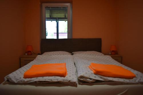 A bed or beds in a room at Veronica nyaralóház