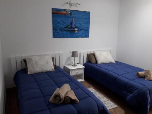 a bedroom with two beds and a person in a canoe at SALEMA in Caleta de Sebo