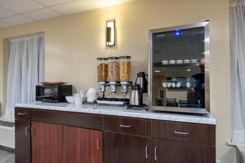 a kitchen with a counter with a coffee maker at Red Roof Inn PLUS+ Tuscaloosa - University in Tuscaloosa