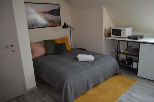 a bedroom with a bed with a towel on it at Rebeka Panzió in Tihany