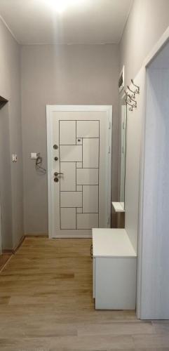 a bathroom with a sink and a door with a mirror at Apartment SEA HOLIDAYS in Burgas
