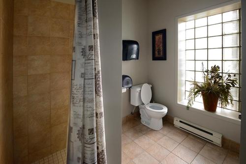 La salle de bains est pourvue de toilettes et d'une fenêtre. dans l'établissement Gîte le 812, à Québec