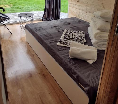 a bed in a room next to a window at Villa Solina in Zawóz