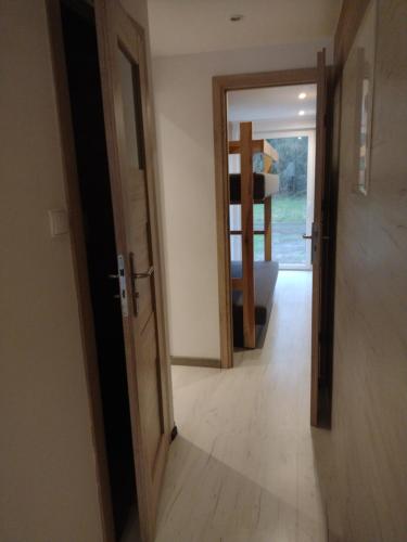 a hallway with a door open to a room at Villa Solina in Zawóz