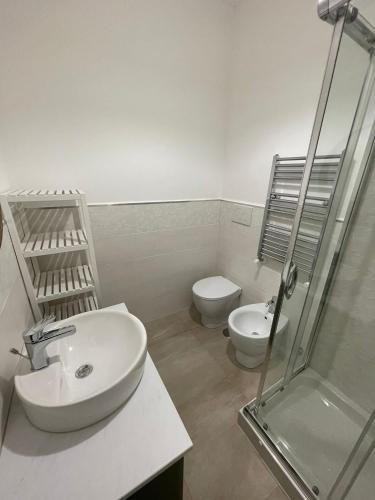 a bathroom with a sink and a toilet and a shower at Alloggio Turistico Dea Bendata in Anzio