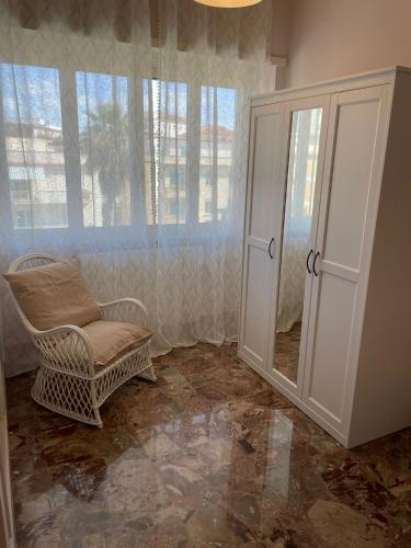 a living room with a chair and a window at Alloggio Turistico Dea Bendata in Anzio