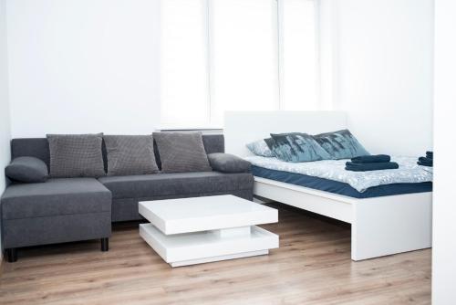 a living room with a couch and a coffee table at Apartament Szczecin Kobalt - Wielkopolska in Szczecin