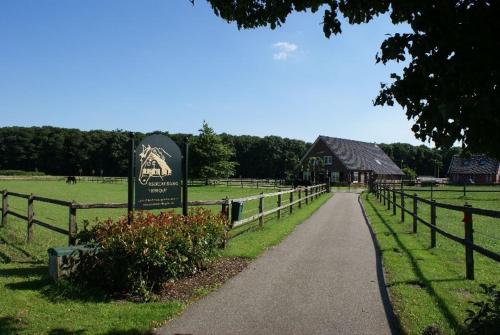 a sign in a field next to a fence at Recreatieoord Hippique in Westendorp