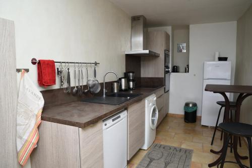 a small kitchen with a sink and a dishwasher at Gite Les Lavandes in Vaison-la-Romaine