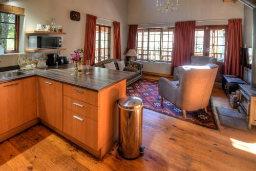 a kitchen with a counter top and a living room at Laragh-on-Hogsback in Hogsback