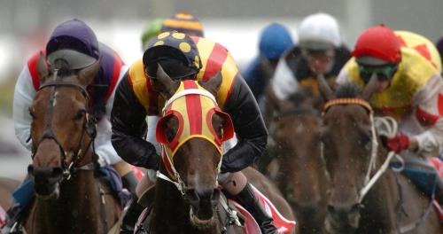 a group of jockeys on horses racing on a track at 2 The Gathering Chester Central in Chester