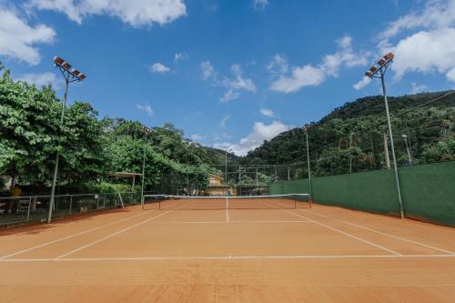 a tennis court with two lights on top of it at Pousada Cantagalo in Itaipava