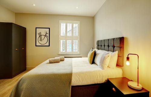 a bedroom with a large bed and a large window at 60 Manchester Road in Altrincham
