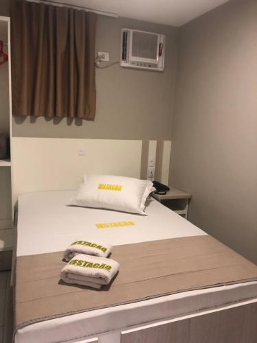 a hospital room with a bed with towels on it at Hotel Estação in Barueri