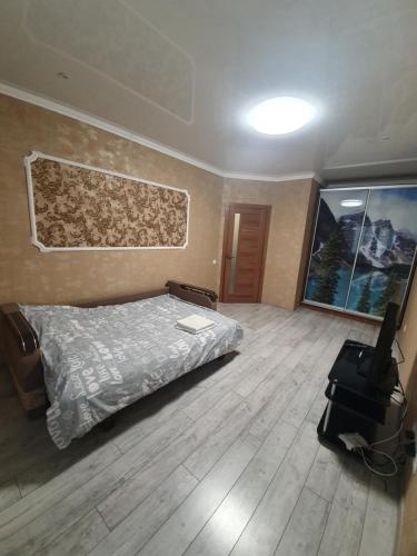 a bedroom with a bed and a flat screen tv at Новобудова.Центр.Перемоги in Luts'k