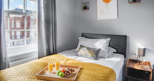 a tray of food on a bed in a room at 3 The Gathering Chester Central in Chester