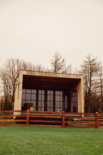 a building with a fence in front of a field at Glasson Lakehouse in Athlone