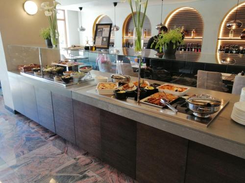 a buffet line with many different types of food at NOVAK apartman in Vrnjačka Banja