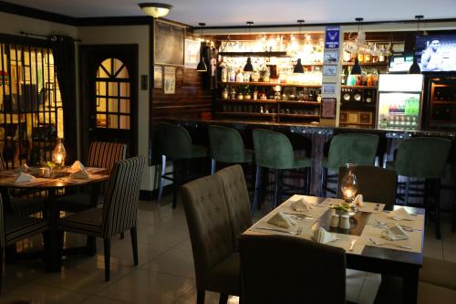 a restaurant with tables and chairs and a bar at Harmony Marina Suites in Rodney Bay Village