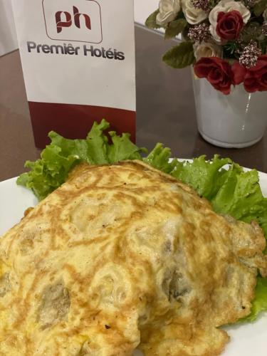 a omelet sitting on a plate with a salad at Barueri Premiêr Hotel in Barueri