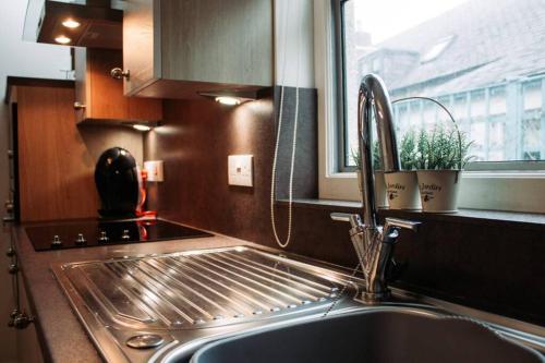 a kitchen with a sink and a window and a sink at Craigewan Cottage Seatown Cullen in Cullen