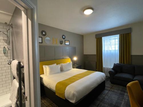 a hotel room with a bed and a couch at The County Hotel in Haverfordwest