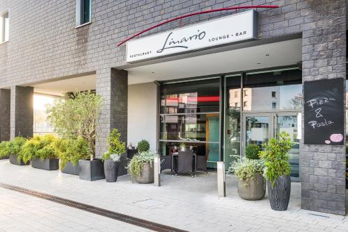 a store front with potted plants in front of it at Hotel Wolfsburg Centrum, Affiliated by Meliá in Wolfsburg