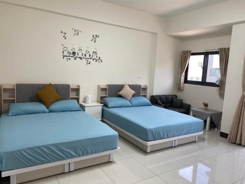 Un pat sau paturi într-o cameră la Qingqing Yi Zhu