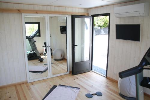 a room with a gym with a sliding glass door at Villa Chaptalia in Bandol