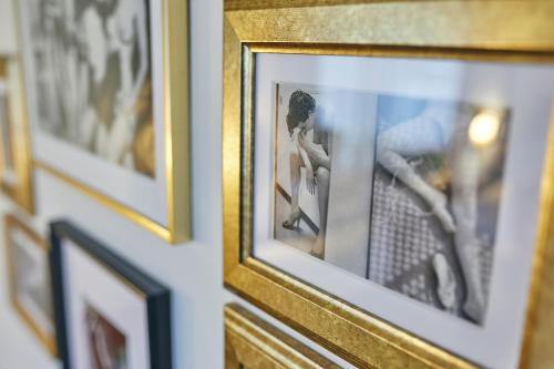 a group of pictures hanging on a wall at Boutiquehotel Liebesglück - adults only in Winterberg