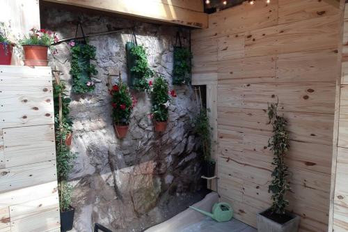 a stone wall with potted plants on it at La Petite Maison Dans la Vallée in Avallon