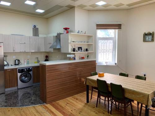 a kitchen with a table and a table and chairs at Luxury Villa with pool and waterfall in Bina